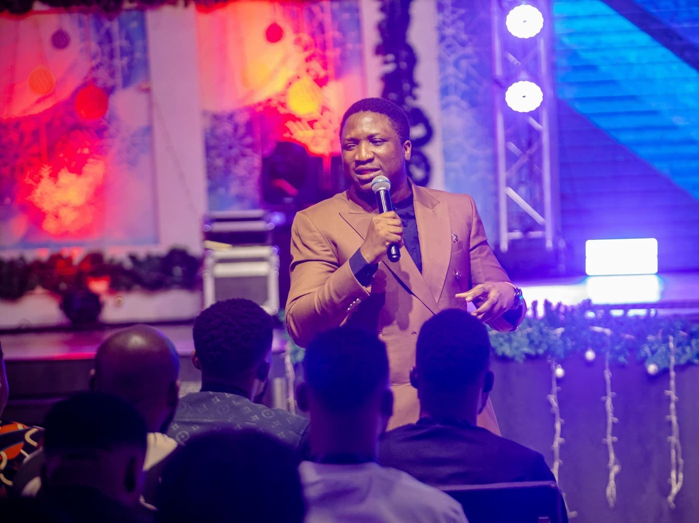 Teaching from the stage at a Caleb Dada Ministries gathering